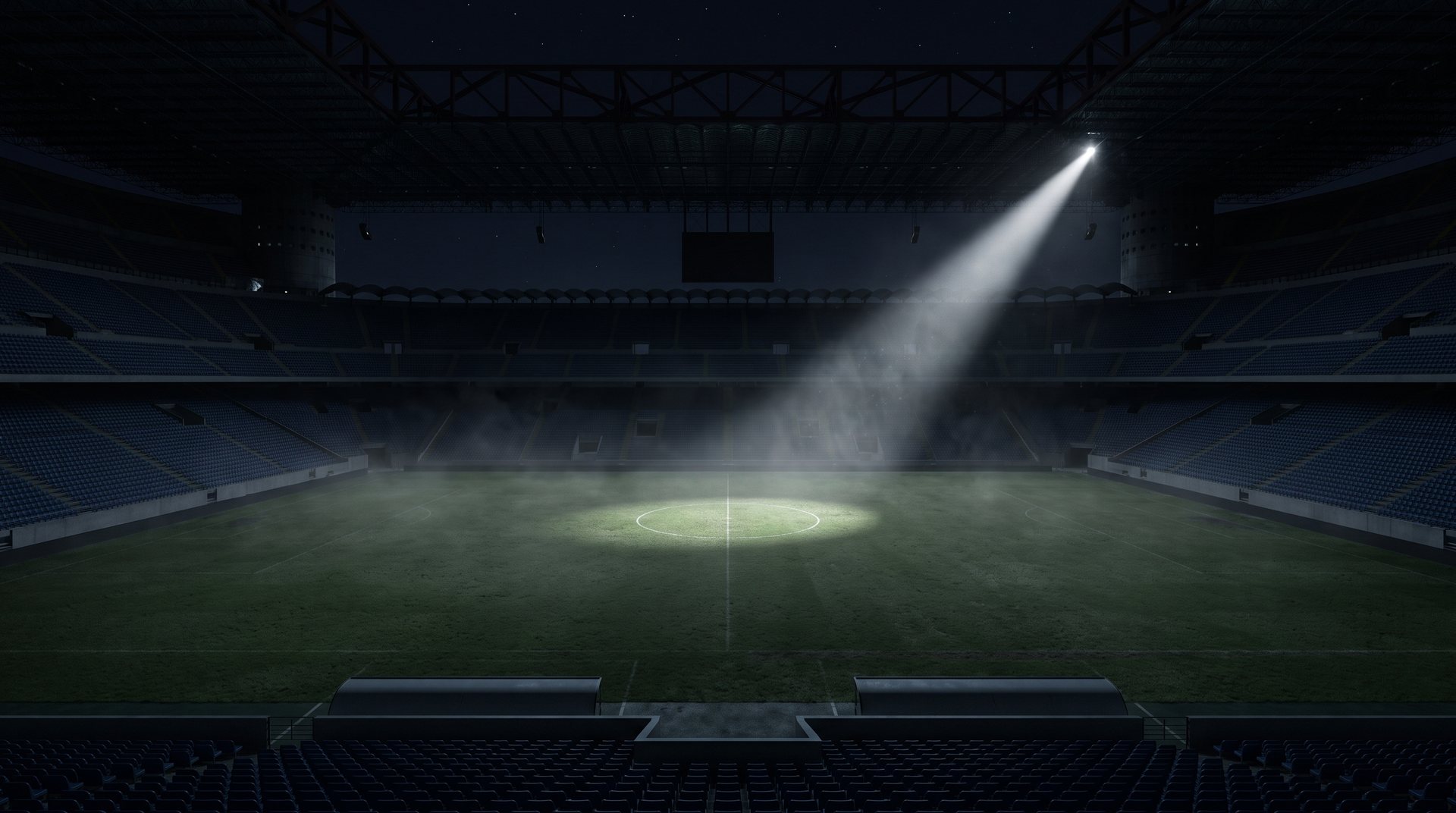 A single spotlight on an empty stadium field